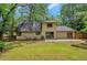 Exterior view of a home featuring a lush, green lawn and patio area at 112 Valley Rd, Stockbridge, GA 30281
