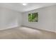 Carpeted bedroom featuring a large window providing ample natural light at 112 Valley Rd, Stockbridge, GA 30281