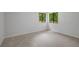 Spacious bedroom featuring neutral carpet, ample light and two windows at 112 Valley Rd, Stockbridge, GA 30281