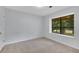 Bright bedroom with a large window offering natural light and outdoor views at 112 Valley Rd, Stockbridge, GA 30281