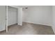 Bright bedroom featuring neutral carpet and an open closet with wire shelving at 112 Valley Rd, Stockbridge, GA 30281