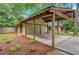 Exterior featuring a side entry carport, and a nicely landscaped yard at 112 Valley Rd, Stockbridge, GA 30281