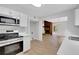 Bright kitchen features stainless steel appliances, light countertops, and modern white cabinets at 112 Valley Rd, Stockbridge, GA 30281