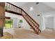 View of living room and staircase; bright kitchen and windows provide natural light at 112 Valley Rd, Stockbridge, GA 30281