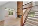 Spacious living room with wood burning fireplace, high ceilings and large windows with staircase at 112 Valley Rd, Stockbridge, GA 30281