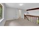 Cozy loft area with neutral carpet and wooden railing to lower floor at 112 Valley Rd, Stockbridge, GA 30281