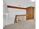 View of the loft with wooden beam and railing overlooking the stairway at 112 Valley Rd, Stockbridge, GA 30281