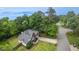 Aerial view of a charming home featuring mature trees, a well-manicured lawn, and a long driveway at 1245 Grace Hadaway Ln, Lawrenceville, GA 30043