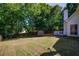Expansive backyard featuring mature trees, a wooden fence, and a storage shed at 1245 Grace Hadaway Ln, Lawrenceville, GA 30043