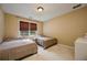 Bedroom featuring two beds, neutral walls, and a window at 1245 Grace Hadaway Ln, Lawrenceville, GA 30043