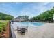 Well-maintained community pool with ample seating and a clubhouse in the background at 1245 Grace Hadaway Ln, Lawrenceville, GA 30043