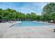 Large community pool surrounded by lounge chairs and lush greenery at 1245 Grace Hadaway Ln, Lawrenceville, GA 30043