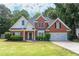 Charming two-story brick home with a well-manicured lawn and lush landscaping, creating inviting curb appeal at 1245 Grace Hadaway Ln, Lawrenceville, GA 30043