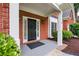 Close-up of the front door, showcasing a black door with sidelights and a gray porch at 1245 Grace Hadaway Ln, Lawrenceville, GA 30043