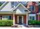 Inviting front porch featuring brick columns, manicured bushes, and a black front door at 1245 Grace Hadaway Ln, Lawrenceville, GA 30043