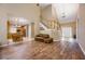 Open-concept living space with hardwood floors, a staircase, and a view into the kitchen at 1245 Grace Hadaway Ln, Lawrenceville, GA 30043