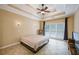This primary bedroom has a tray ceiling, ceiling fan, and large window at 1245 Grace Hadaway Ln, Lawrenceville, GA 30043