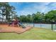 Community playground with slides, climbing structures, and a fenced tennis court at 1245 Grace Hadaway Ln, Lawrenceville, GA 30043
