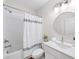 Bathroom featuring tiled shower over tub with decorative shower curtain, white vanity and round mirror at 1247 Zucchini Se Cir, Atlanta, GA 30315