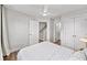 Bedroom with white walls, a ceiling fan, an open doorway, and a double door closet at 1247 Zucchini Se Cir, Atlanta, GA 30315