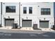 Modern townhome exterior featuring individual garages and crisp white siding at 1247 Zucchini Se Cir, Atlanta, GA 30315