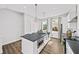 The bright kitchen features a central island with a sink, stainless steel appliances, and plentiful storage at 1247 Zucchini Se Cir, Atlanta, GA 30315