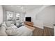 Bright living room featuring hardwood floors, a comfortable sofa, and plenty of natural light at 1247 Zucchini Se Cir, Atlanta, GA 30315