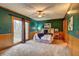 Spacious bedroom with wainscotting, plush carpeting, dark green walls and access to outdoor deck at 3452 Monica Lane Southwest Sw Ln, Conyers, GA 30094
