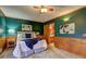 Bright bedroom with plush carpeting, dark green walls, wainscotting, art, and access to an ensuite bathroom at 3452 Monica Lane Southwest Sw Ln, Conyers, GA 30094