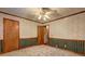 Bedroom with neutral wallpaper, ceiling fan, carpet, and wooden trim at 3452 Monica Lane Southwest Sw Ln, Conyers, GA 30094