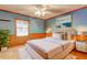 Comfortable bedroom with wainscotting, light blue walls, plush carpeting and bright natural light at 3452 Monica Lane Southwest Sw Ln, Conyers, GA 30094