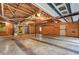 Large, unfinished garage space with exposed ceiling and concrete floors at 3452 Monica Lane Southwest Sw Ln, Conyers, GA 30094