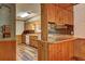Vintage-style kitchen with wood cabinets, unique wallpaper, and plenty of countertop space at 3452 Monica Lane Southwest Sw Ln, Conyers, GA 30094
