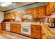 Well-lit kitchen with wood floors, white appliances, patterned backsplash and butcher block countertops at 3452 Monica Lane Southwest Sw Ln, Conyers, GA 30094