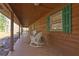 Long porch with rocking chairs, wood ceiling and view of the trees at 3452 Monica Lane Southwest Sw Ln, Conyers, GA 30094