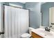 Bathroom featuring a shower with a white curtain, vanity and sink at 374 Beaumont Farms Dr, Sharpsburg, GA 30277