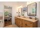 Bright bathroom with a double vanity, decorative mirrors, and a view into the bedroom at 374 Beaumont Farms Dr, Sharpsburg, GA 30277