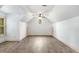 Spacious bonus room featuring angled ceilings, wood-look floors, and natural light at 374 Beaumont Farms Dr, Sharpsburg, GA 30277