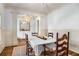 Well-lit dining room features wainscoting detail, decorative chandelier, and seating for six, perfect for hosting at 374 Beaumont Farms Dr, Sharpsburg, GA 30277
