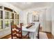Formal dining room with wainscoting, plantation shutters, and an elegant chandelier for memorable gatherings at 374 Beaumont Farms Dr, Sharpsburg, GA 30277