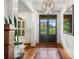 Bright foyer with hardwood floors, a decorative chandelier, and a view of the well-manicured front lawn at 374 Beaumont Farms Dr, Sharpsburg, GA 30277