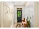 Hallway featuring a wooden bench, coat rack and a view out the back door at 374 Beaumont Farms Dr, Sharpsburg, GA 30277