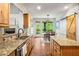 Kitchen featuring granite countertops, stainless steel appliances, and an island with wooden cabinets at 374 Beaumont Farms Dr, Sharpsburg, GA 30277
