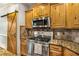 The kitchen features granite countertops, stainless steel appliances, and a rustic sliding barn door at 374 Beaumont Farms Dr, Sharpsburg, GA 30277