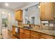 Kitchen features granite countertops, stainless appliances, and a view to an adjacent dining area at 374 Beaumont Farms Dr, Sharpsburg, GA 30277