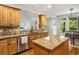 Kitchen area featuring granite countertops, stainless steel appliances and open access to the dining area at 374 Beaumont Farms Dr, Sharpsburg, GA 30277