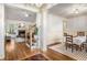 Open-concept living room and dining area with hardwood floors, cozy fireplace, and ample natural light at 374 Beaumont Farms Dr, Sharpsburg, GA 30277
