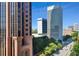 View of skyscrapers and tree lined street in the city at 620 Peachtree Ne St # 1111, Atlanta, GA 30308
