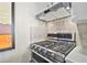 Close up of a stainless steel gas range with double oven and modern vent hood at 620 Peachtree Ne St # 1111, Atlanta, GA 30308