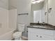 Bathroom featuring a shower-tub combo and vanity with granite countertop at 766 Chapman St, Jonesboro, GA 30238